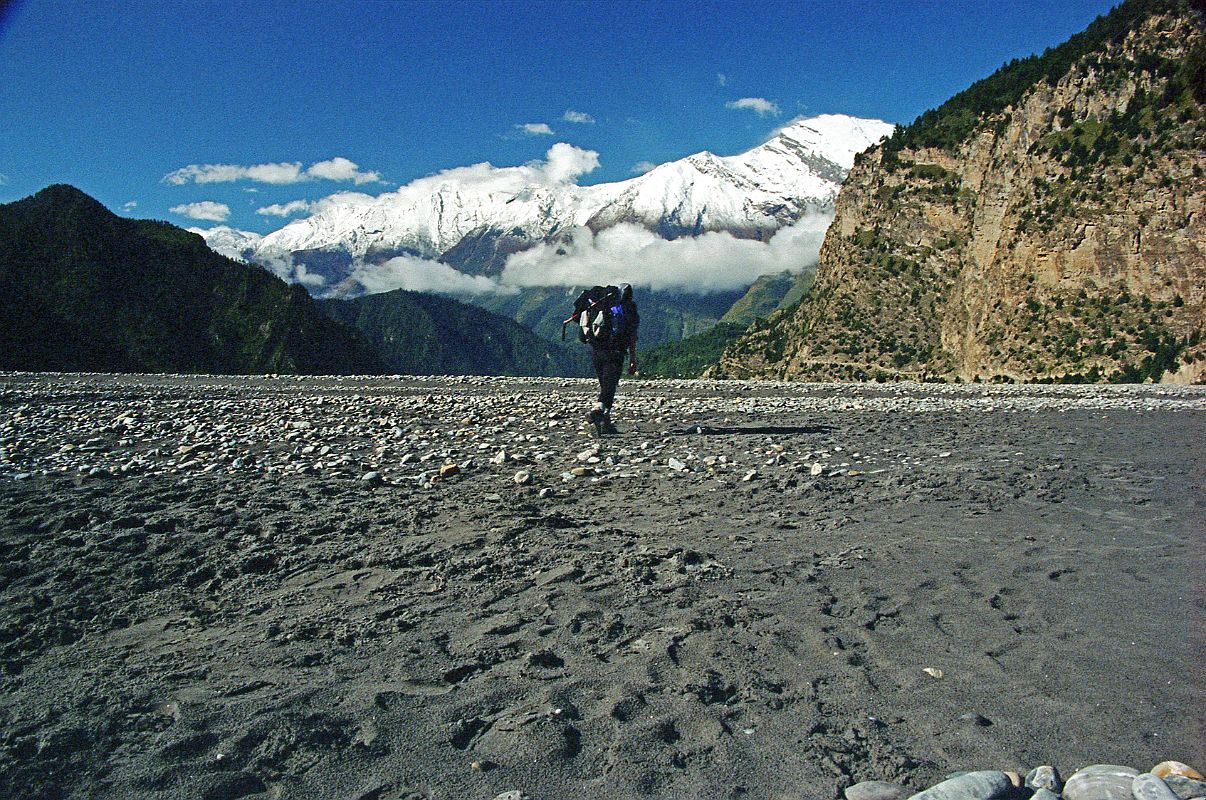 303 Jerome Ryan Trekking On Kali Gandaki Riverbed After Tukuche After passing through Tukuche, Jerome Ryan walked along the broad Kali Gandaki riverbed until I noticed the other trekkers were using the trail on the cliff side. Luckily I crossed a few streams and scrambled back to the trail without getting my boots wet.